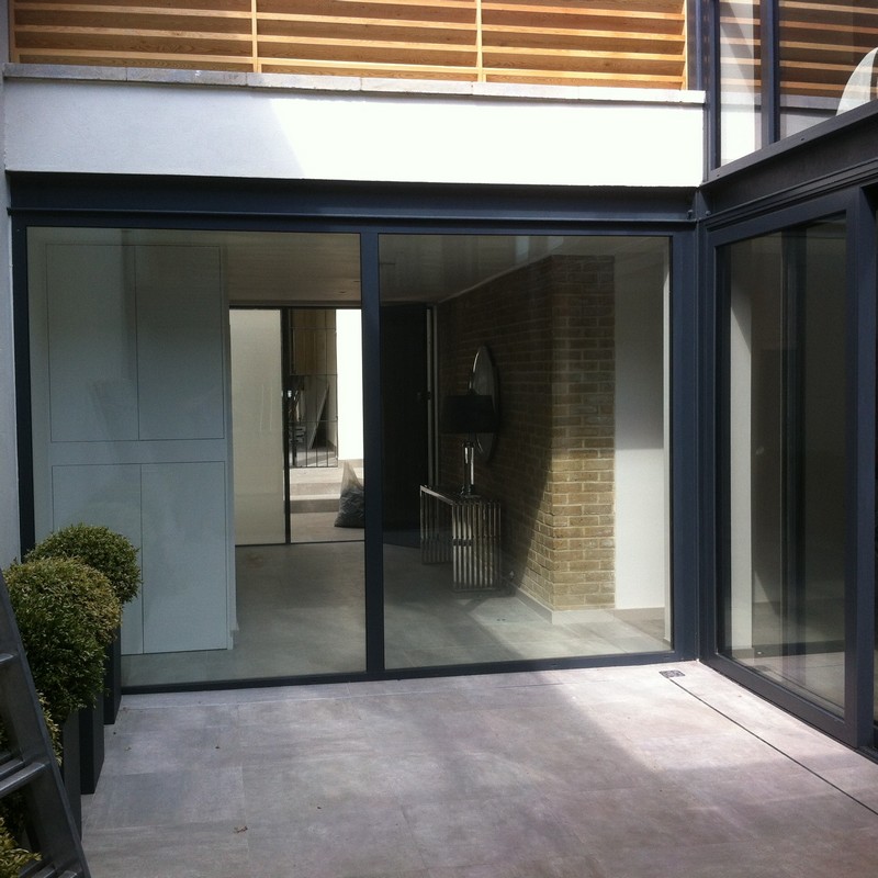 Floor-to-ceiling sliding doors opening to courtyard in Streatham