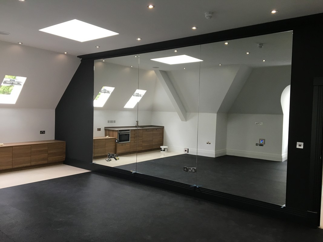 Frameless glass wall dividing loft conversion in Streatham