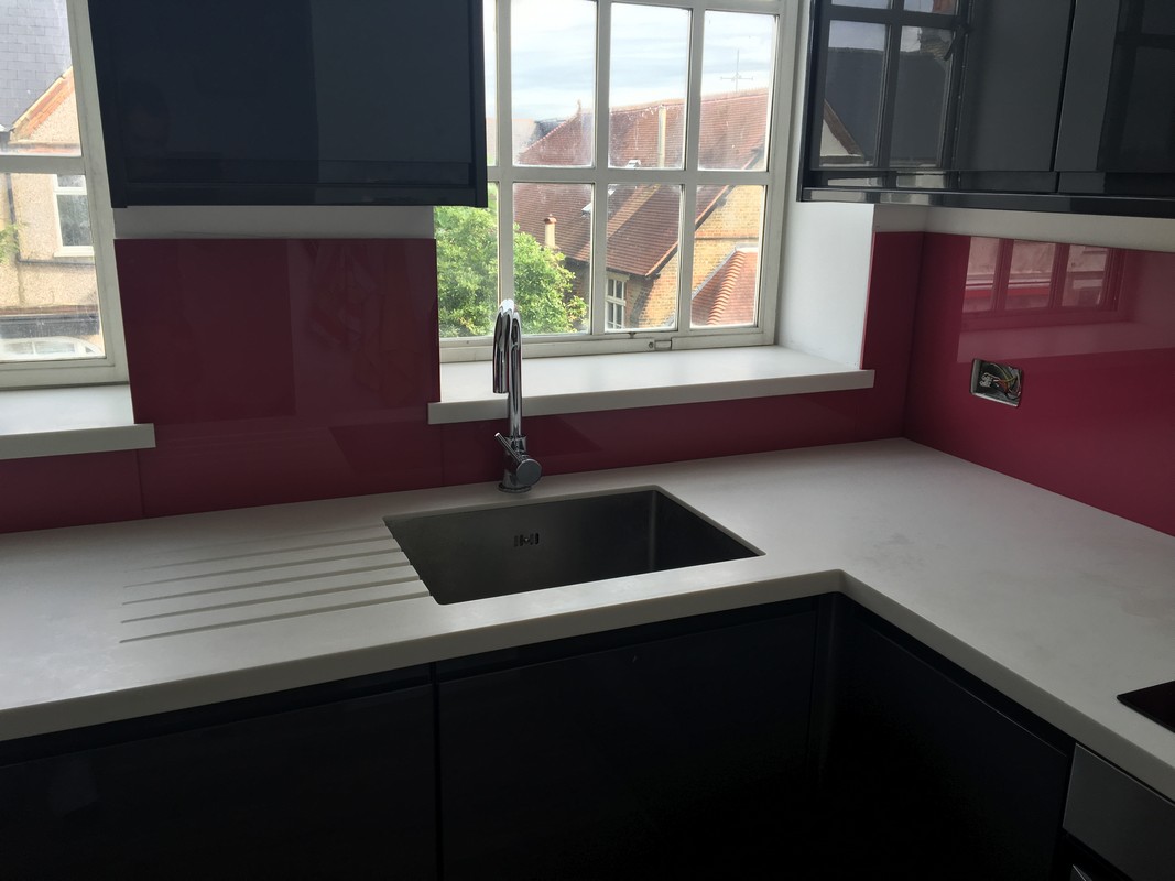 Deep plum coloured glass splashback in modern Streatham kitchen